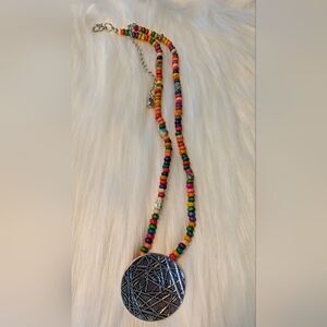 Rainbow multicolored wooden beaded necklace with silver medallion.